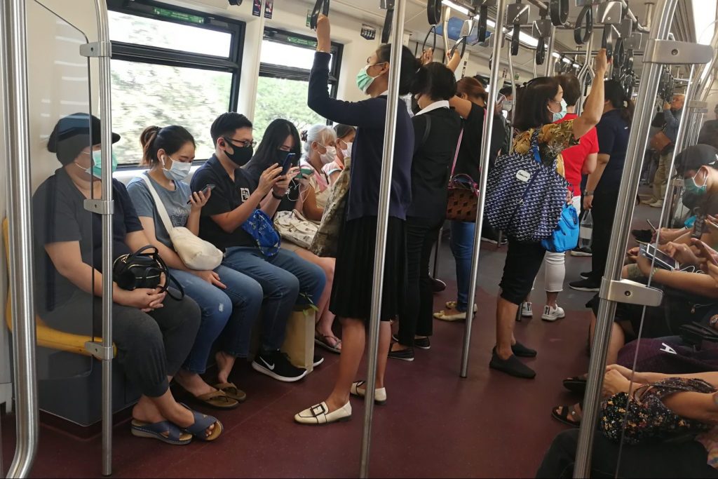 Tourists and locals don masks in Bangkok.