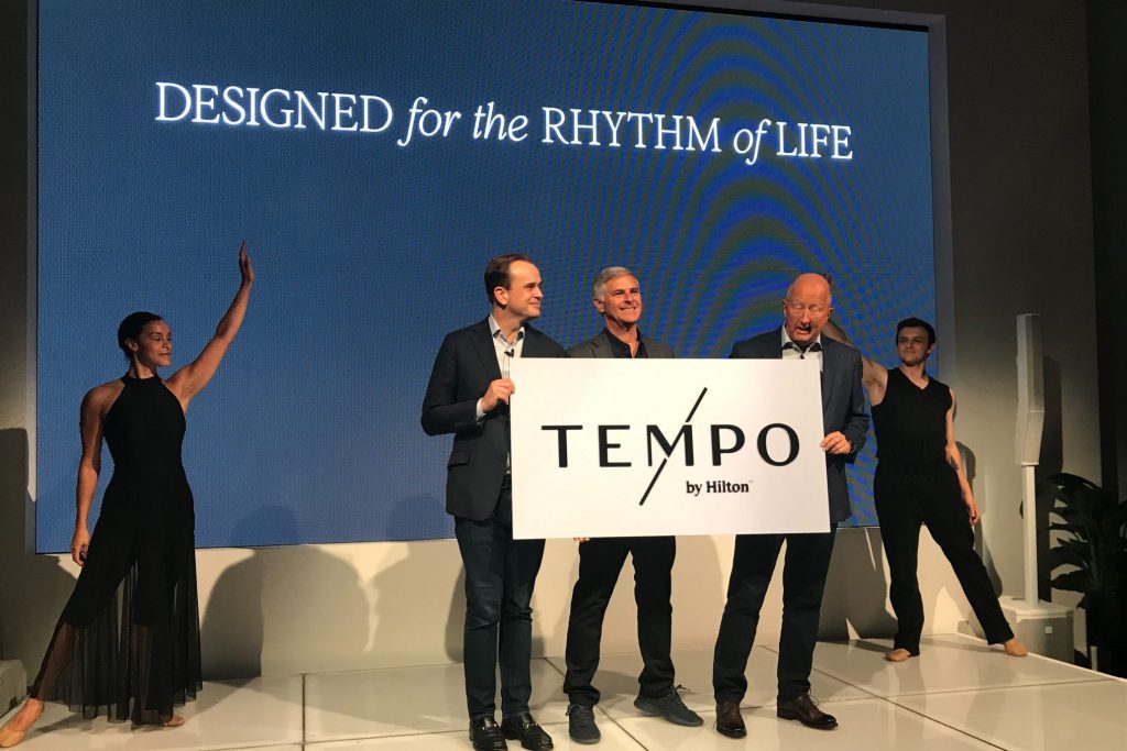 Hilton executives, including (l. to r.) head of brand development Phil Cordell, CEO Chris Nassetta, and chief customer officer Jon Witter, celebrate the hotel chain's new brand Tempo on Thursday in New York City.