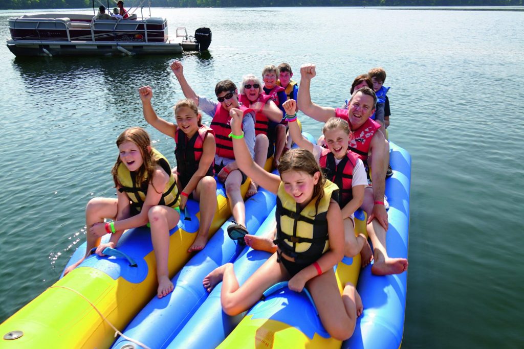 Grandparents and grandchildren enjoy rafting on a trip with Road Scholar in the Ozark Mountains of the United States.