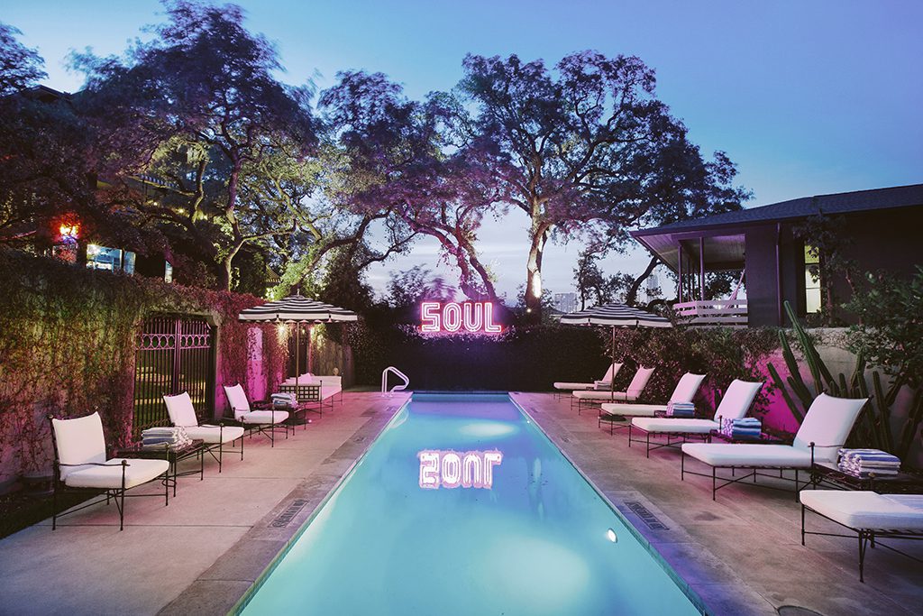 The Hotel Saint Cecilia's pool at dusk in Austin, Texas. Saint Cecilia has a carefully crafted musical soundtrack that taps into the soul of the property and the city of Austin.
