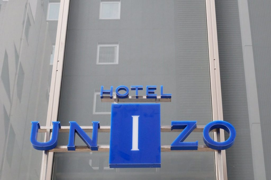 The logo of Hotel Unizo, operated by Japanese hotel operator Unizo Holdings, at the entrance of a hotel in Tokyo, Japan. The company is the subject of a bidding war.