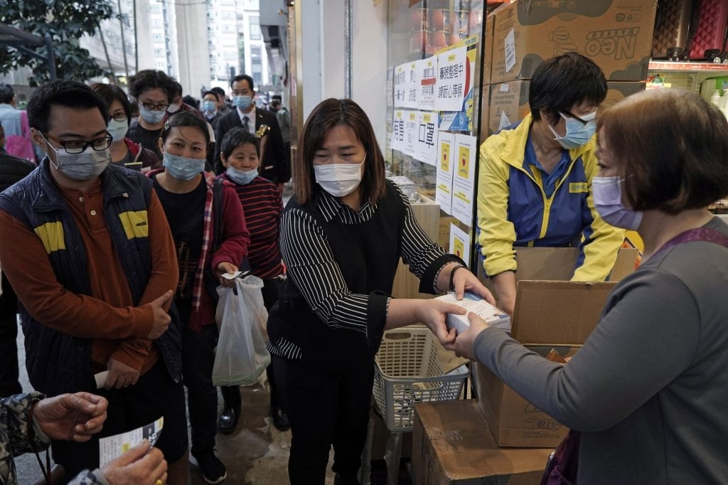 Many tour operators and agents in Asia are just starting on digitalization. Inundated with travel cancellations, companies are struggling to keep up with requests. People queue up to buy face masks in Hong Kong, Friday, Feb. 7, 2020.
