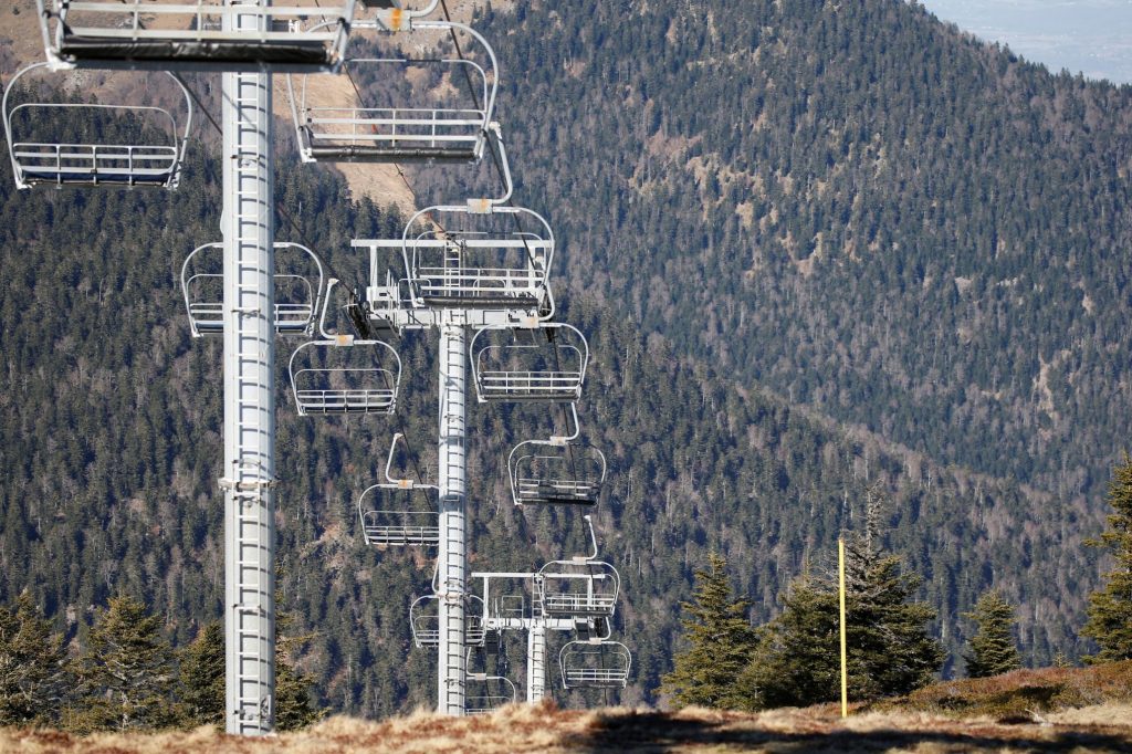 Shown here are chairlifts over ski slopes closed due to lack of snow at the ski resort of The Mourtis in Boutx, France, February 10, 2020. 