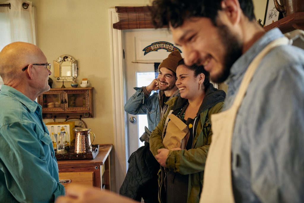 Airbnb host greeting participants in a bread-baking experience in 2019. Airbnb said in 2021 more people are interested in hosting.