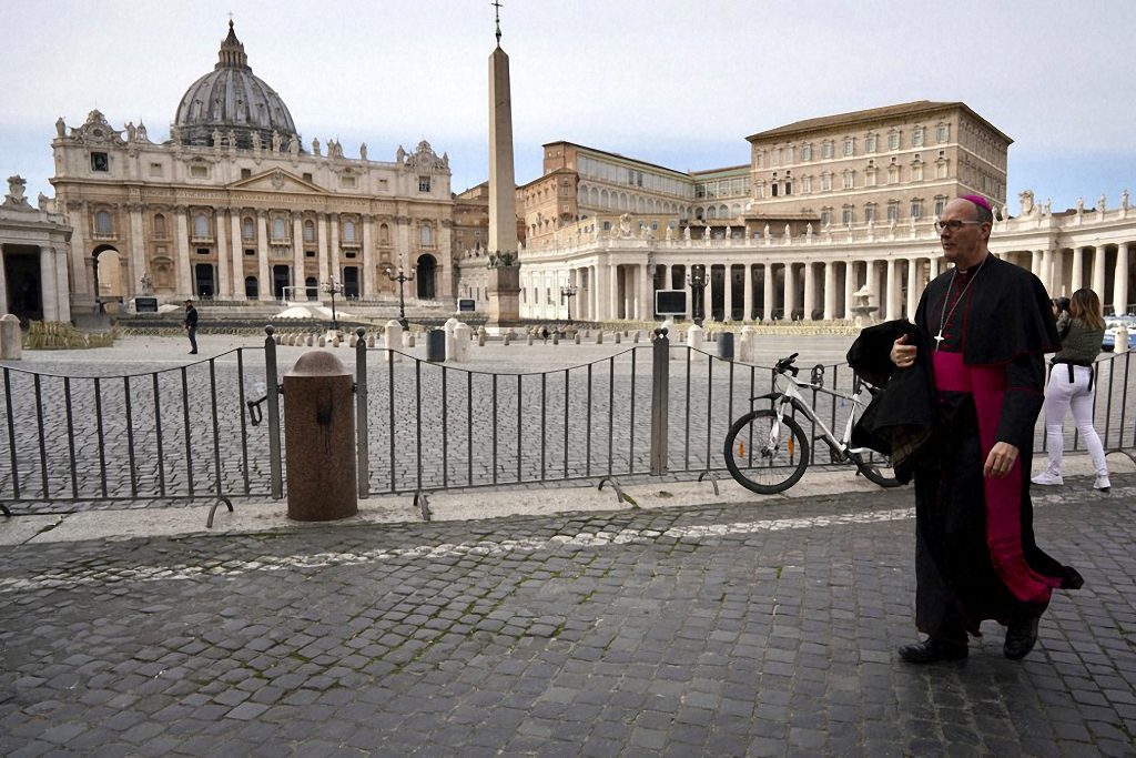 A prelate walks outside St. Peter's Square after the Vatican erected a new barricade at the edge of the square, in Rome, Tues., March 10, 2020. Italy entered a nationwide lockdown after a government decree extended restrictions on movement from the hard-hit north to the rest of the country to prevent the spreading of coronavirus. 