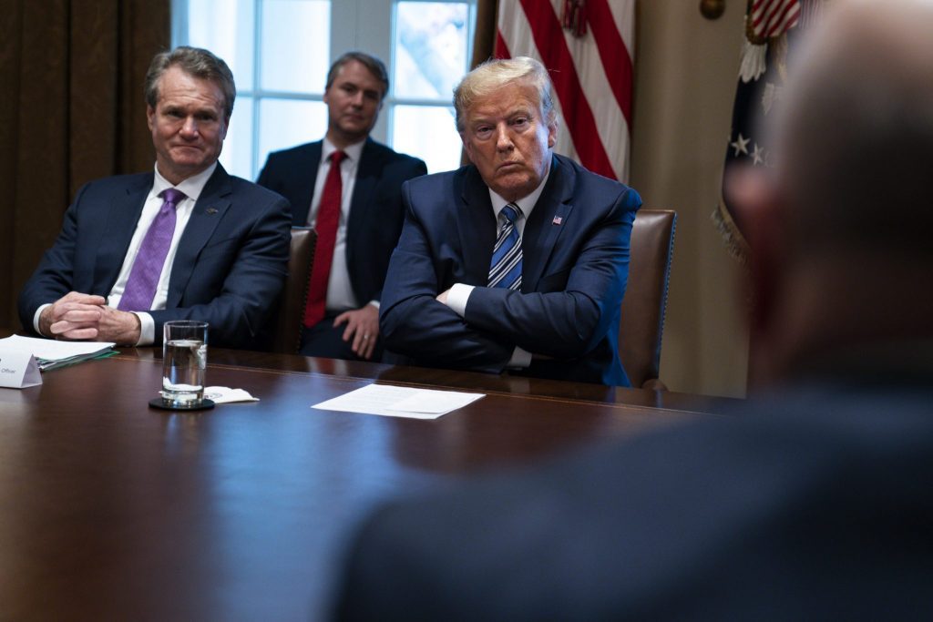 The U.S. State Department is urging Americans to reconsider travel abroad. Bank of America CEO Brian Moynihan, left, and President Donald Trump listen during a meeting with banking industry executives about the coronavirus, at the White House, Wednesday, March 11, 2020, in Washington. 