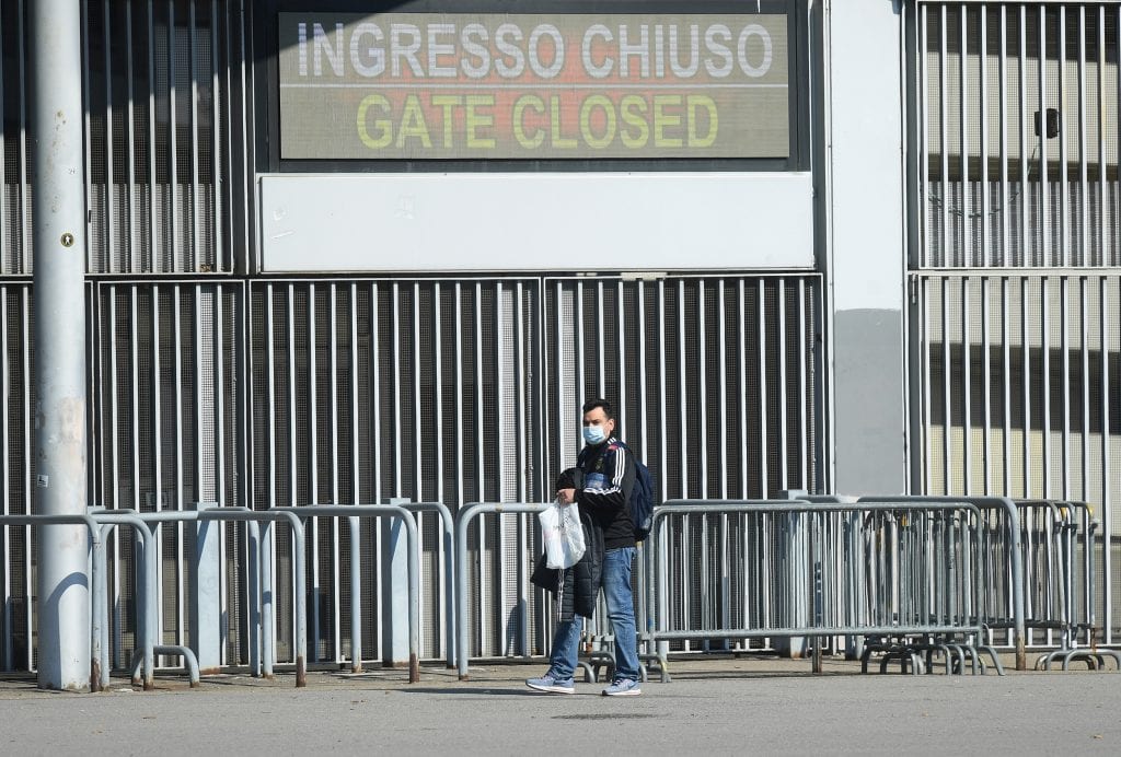Soccer Football - Serie A - AC Milan v Genoa - San Siro, Milan, Italy - March 8, 2020  General view as a man wears a mask outside the stadium before the match is played behind closed doors to spectators as the number of coronavirus cases grows around the world.