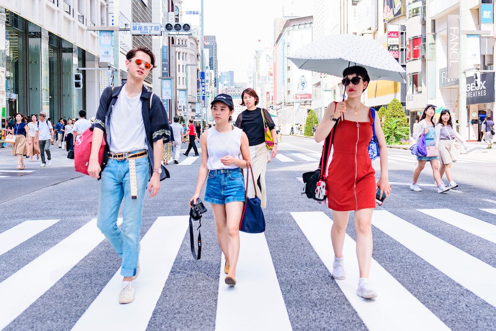 Chinese travelers walking in the pedestrian zone of Ginza, Tokyo.