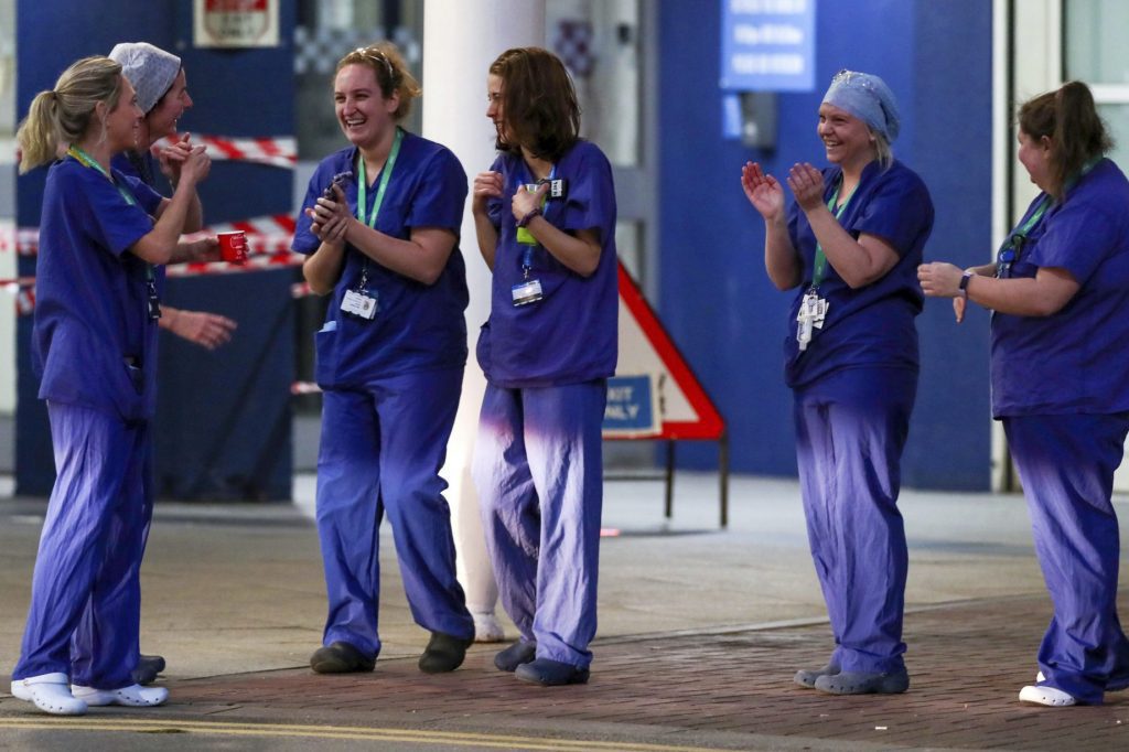 Staff from the Royal Liverpool University Hospital join in a national applause to salute local heroes during the nationwide Clap for Carers NHS initiative to applaud workers fighting the coronavirus pandemic.