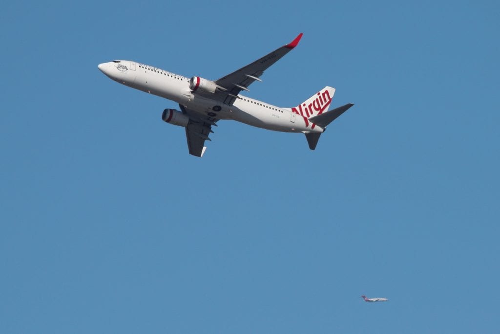 A Virgin Australia Airlines plane takes off from Kingsford Smith International Airport in Sydney, Australia, March 18, 2020.