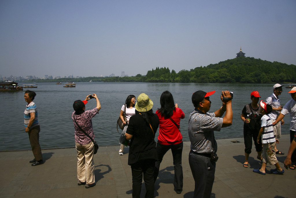 Chinese tourists take photographs