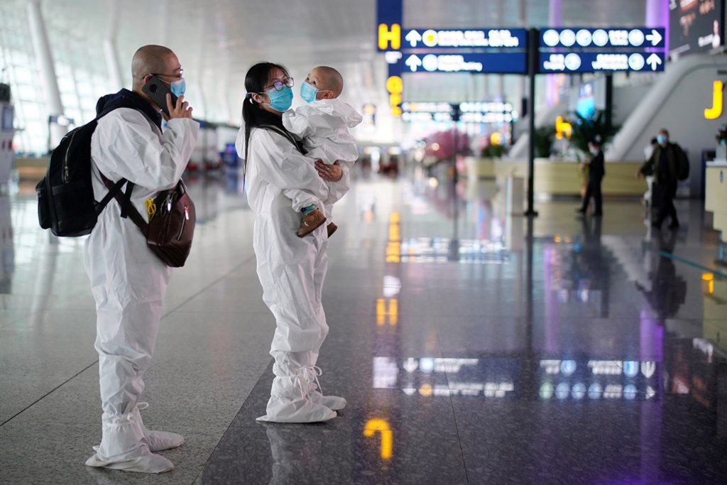 Travellers in protective suits are seen at Wuhan Tianhe International Airport after the lockdown was lifted in Wuhan, the capital of Hubei province and China's epicentre of the novel coronavirus disease outbreak April 2020.