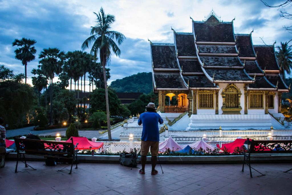 A traveler takes a photo at a temple.