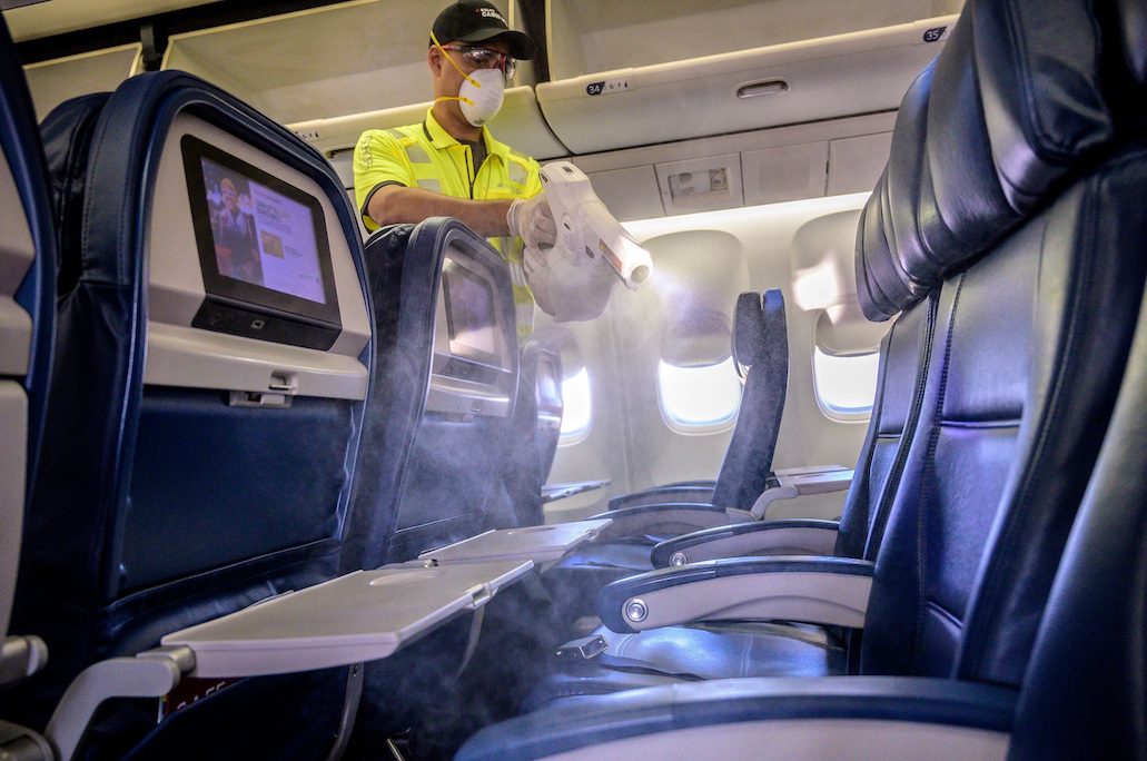 A maintenance worker disinfect the aircraft surfaces on a Boeing 757. The airline is cleaning airplanes more thoroughly. 
