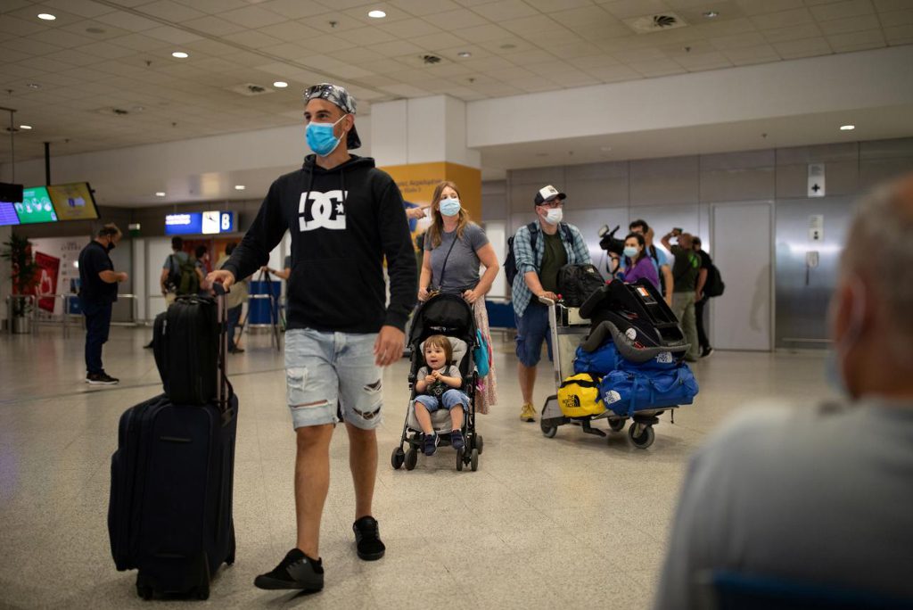 Passengers of a flight from Amsterdam wearing protective face masks arrive at the Eleftherios Venizelos International Airport, following the easing of measures against the spread of coronavirus disease, in Athens, Greece, June 15, 2020. 