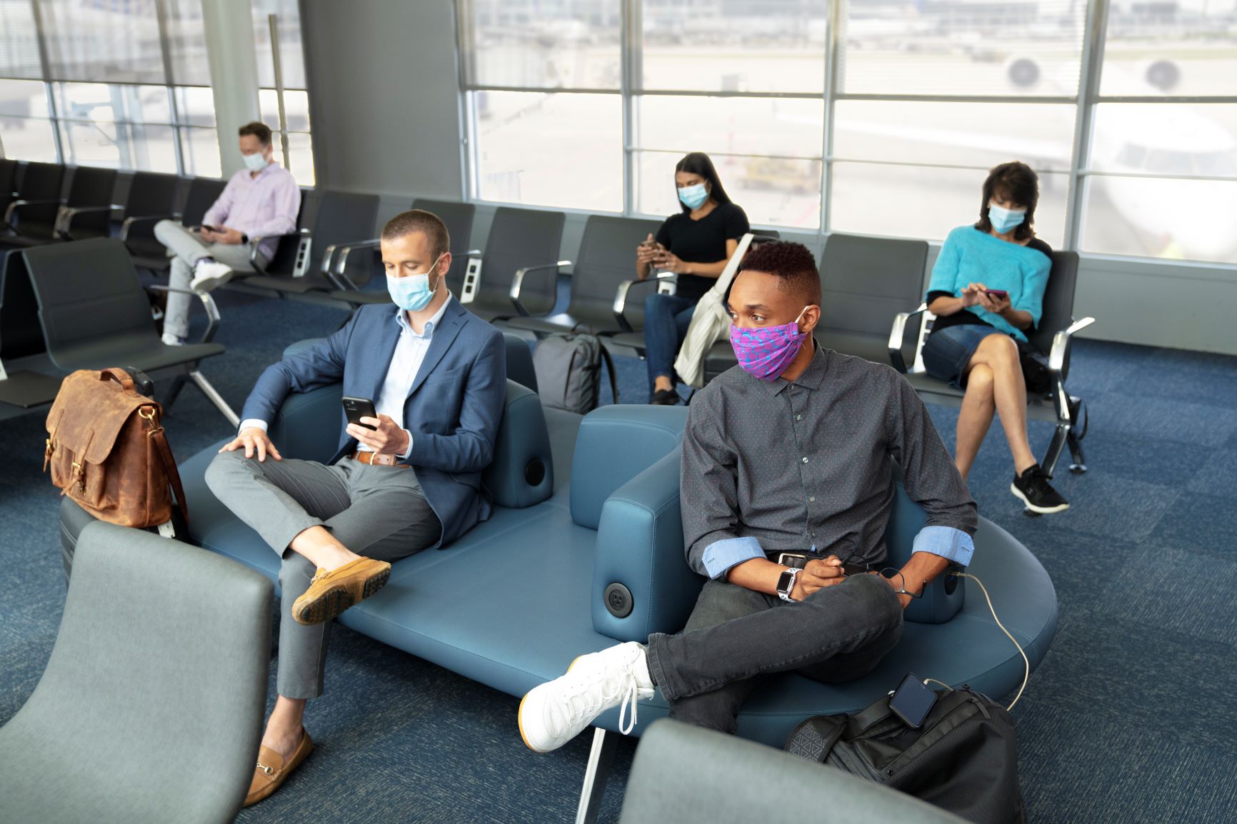 Passengers waiting to board their flights must wear a mask.  