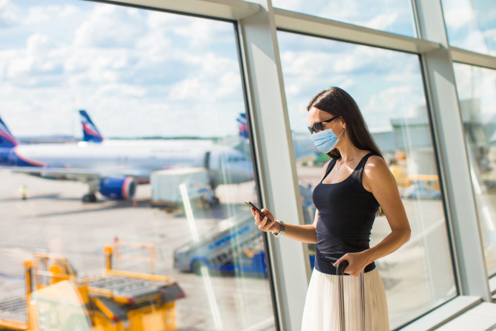 Young tourist woman with baggage in international airport