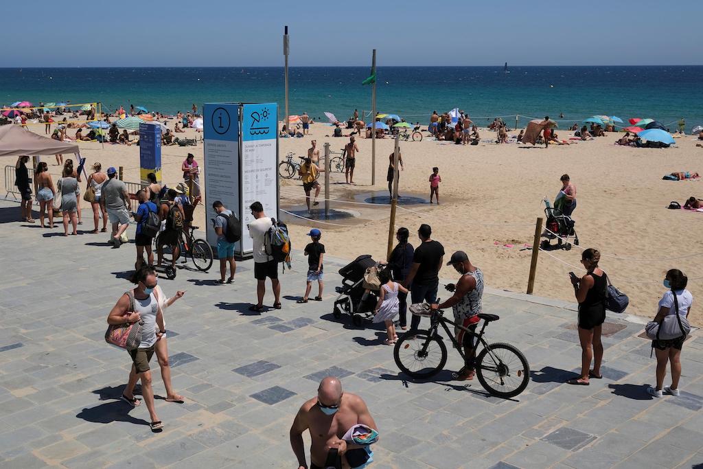 A queue of people for a beach in Spain. 