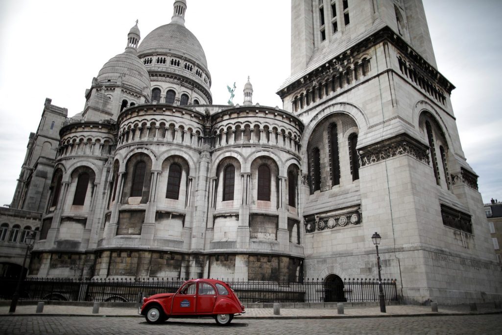 A Citroen 2CV car of the Paris company 2CVParisTour.com is seen parked in front of the Sacre-Coeur basilica of Montmartre in Paris, France, June 26, 2020. Paris has suffered a lack of tourism due to the pandemic, as the example of city sightseeing tours in a Citroen 2CV shows.