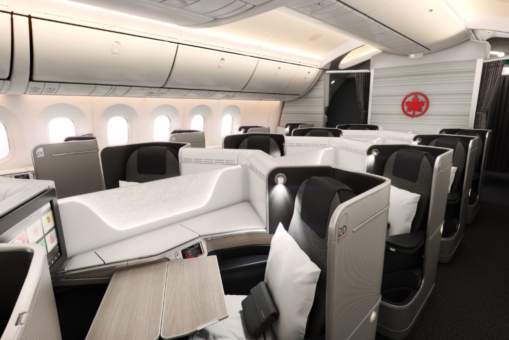 An interior image of a business class cabin on an Air Canada Boeing 787 jet. The carrier has been perhaps the most eager adopter of ATPCO's NDC Exchange.