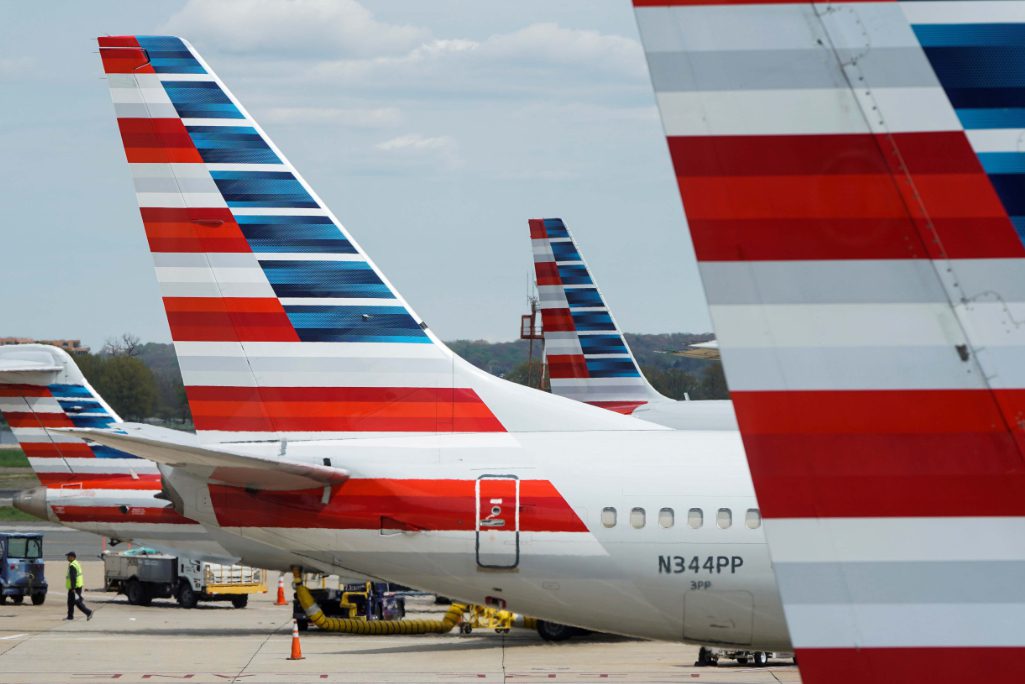 A member of a ground crew walks past American Airlines planes parked at the gate during the coronavirus disease outbreak at Ronald Reagan National Airport in Washington, U.S., April 5, 2020. 