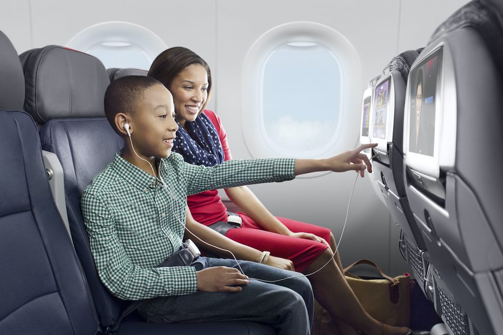 American Airlines has introduced new customer-friendly policies. Pictured are a parent and child on one of the airline's aircraft.