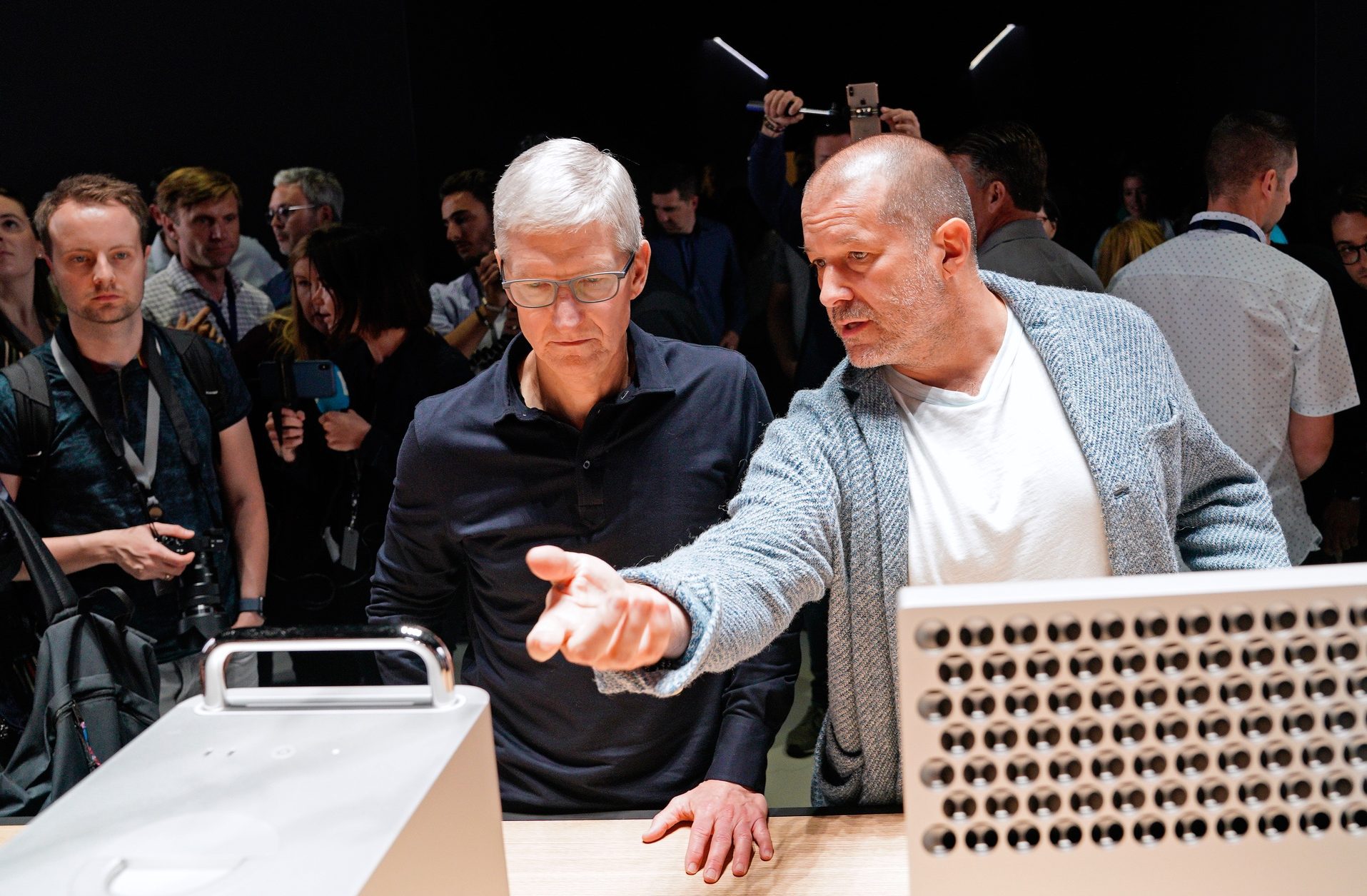 Apple CEO Tim Cook and Chief Design Officer Jonathan Ive (R) look over a Mac Pro during Apple's annual Worldwide Developers Conference in San Jose, California, U.S. June 3, 2019. Ive was recently hired by Airbnb. 