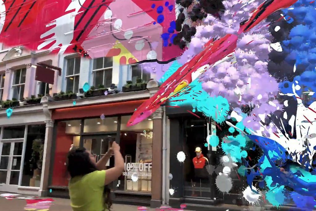 A user of Snap's new technology at London's Carnaby Street. It's a proof of concept for travelers using augmented reality routinely. Snapchat and Apple are rolling out hardware and software that improves the usefulness of augmented reality in travel, including for cheap advertising.