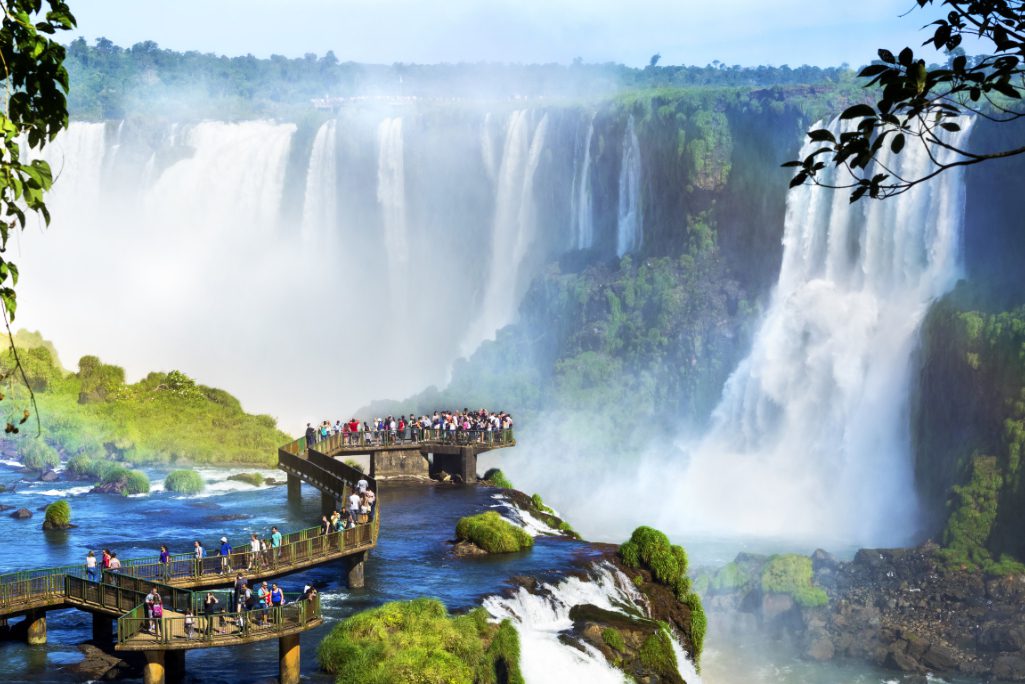 Tourists at Iguazu Falls, one of the world's great natural wonders, on the border of Brazil and Argentina. Online travel booking company Despegar has bought fintech firm Koin as a tool to appeal to many offline travel buyers who don't use banks.