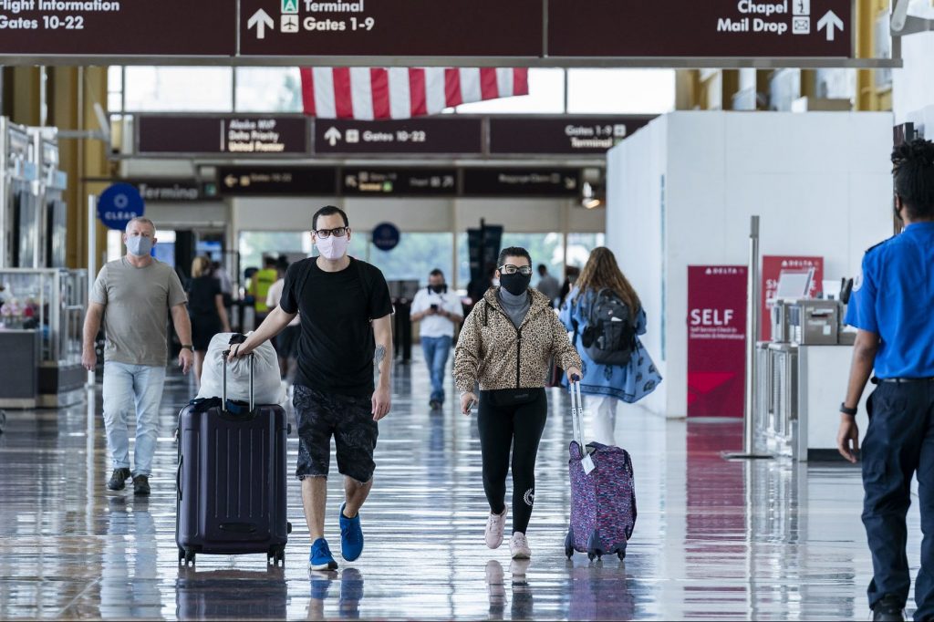 Travelers walk to their respective gates at Reagan National Airport in Washington, D.C. on August 24, 2020.