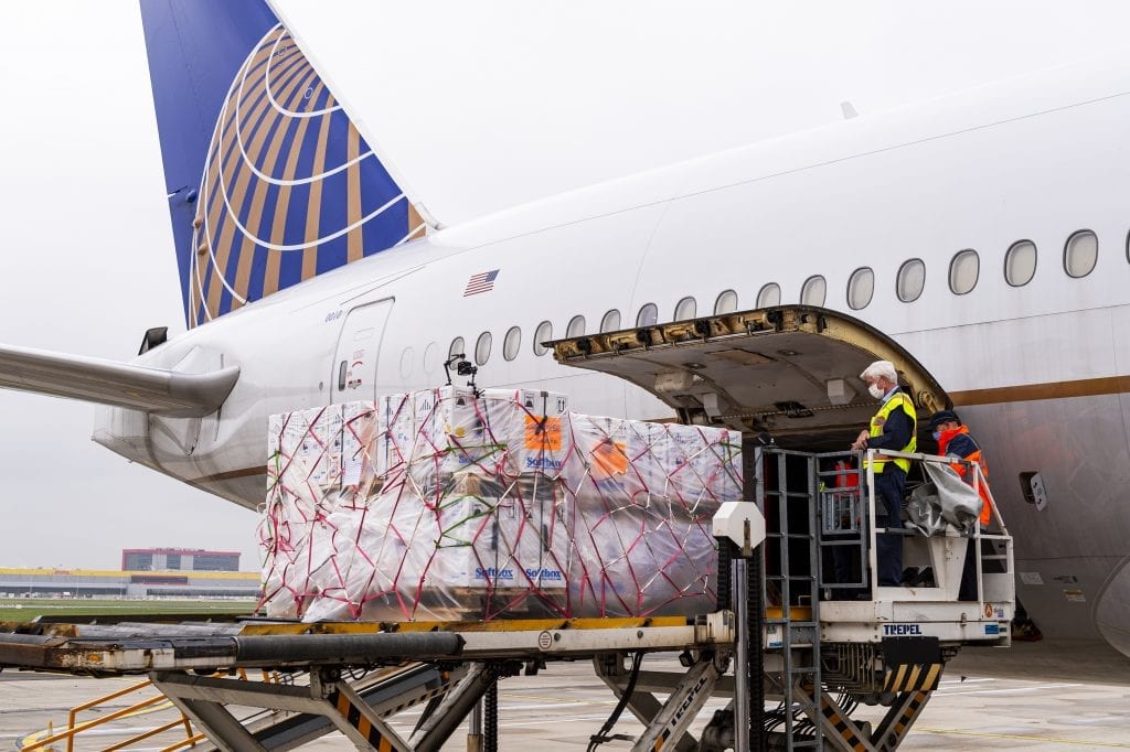 United Airlines employees earlier this week load the Pfizer/BioNTech mRNA vaccine and dry ice onto the belly of the plane.