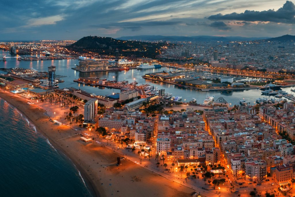 Coastal, aerial view of Barcelona, in Catalonia in Spain, at night. 