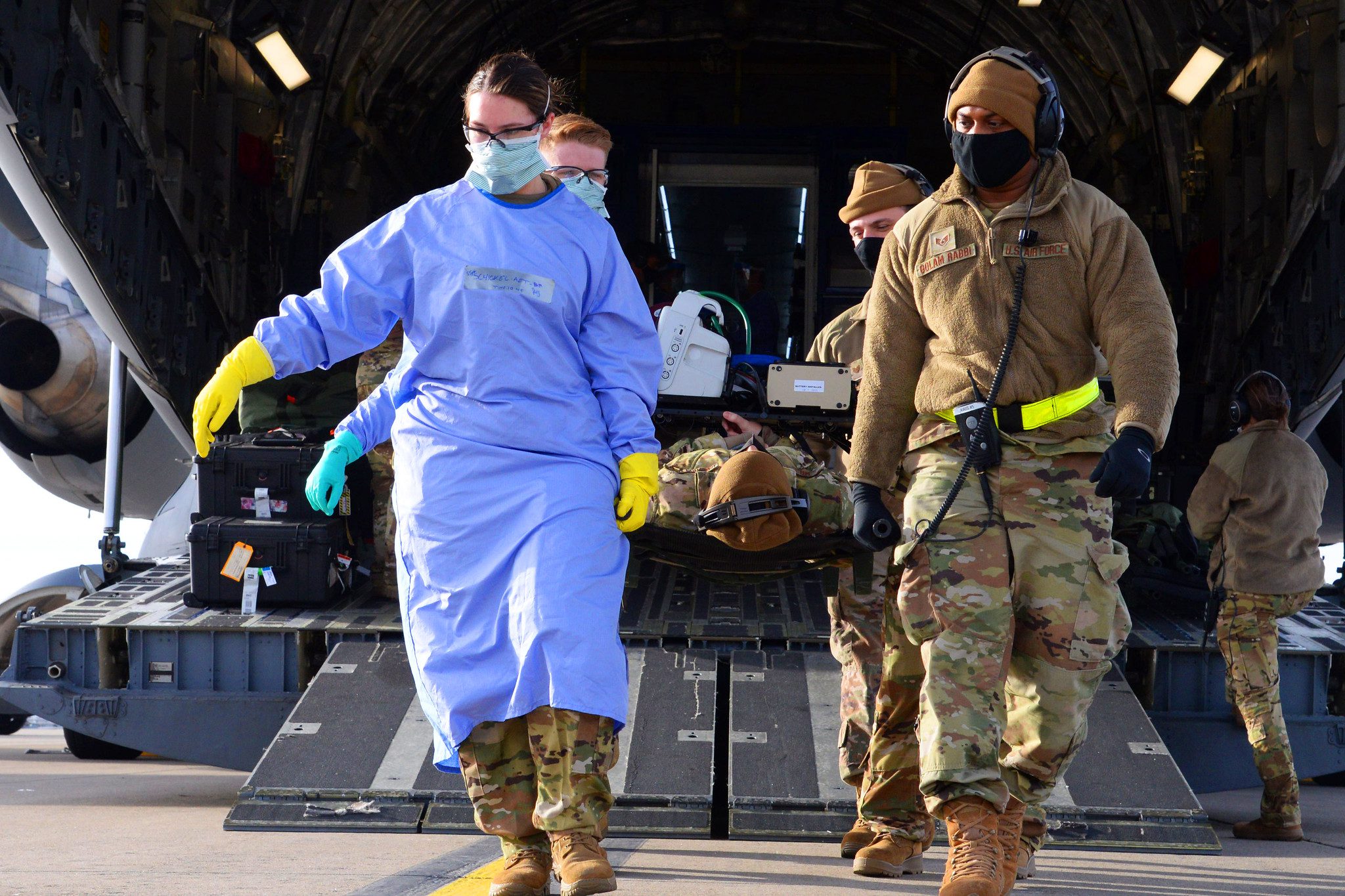 Airmen assigned to the 10th Expeditionary Aeromedical Evacuation Flight unload a litter with a simulated patient from a C-17 Globemaster III aircraft during training at Ramstein Air Base, Germany, on Jan. 26, 2021.
