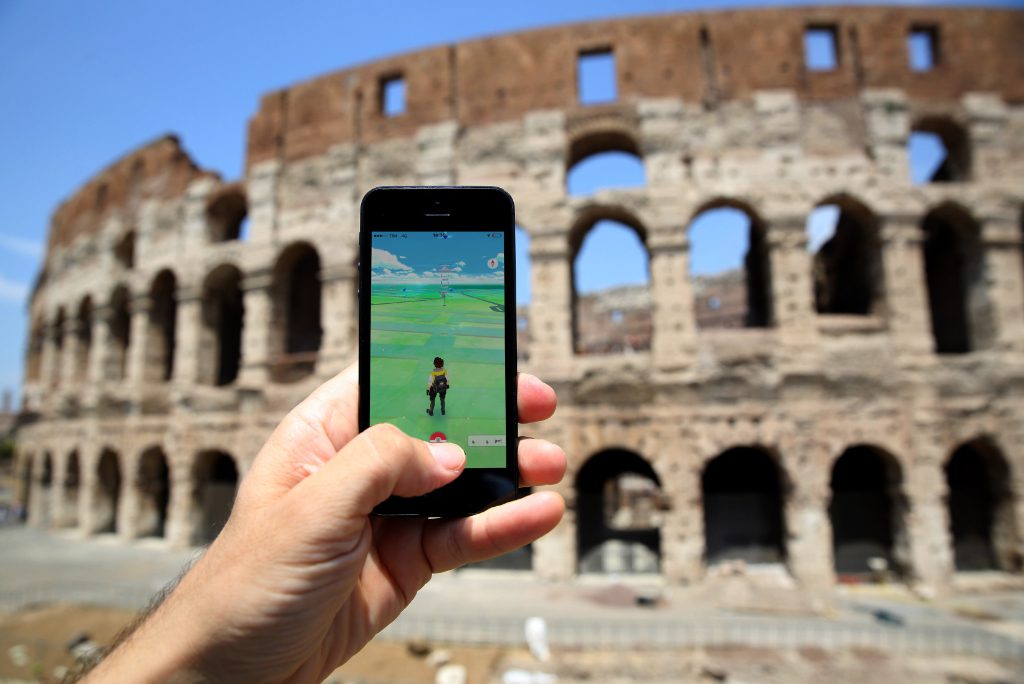 A view of the ancient ruins of the Colosseum in Rome and a mobile app for the gamification of experiential tourism.
