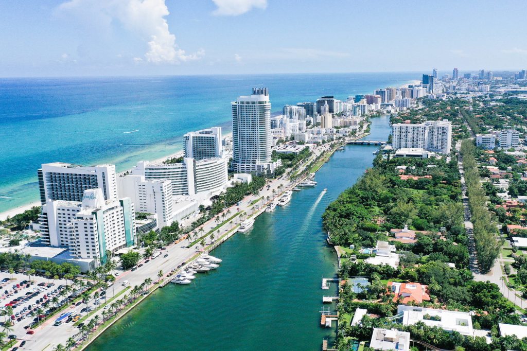 Travelers continue to flock to markets like Miami Beach (pictured). But hotels, airlines, and other travel sectors are struggling to meet demand.