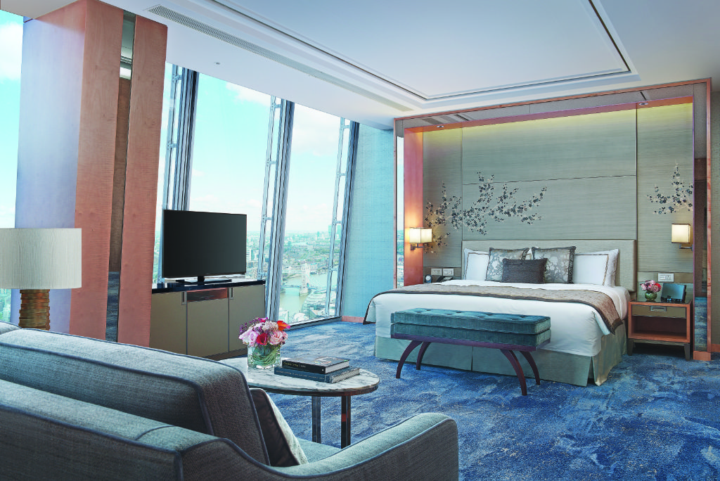 An image of an "iconic Shard suite" with a backdrop of London from Europe's tallest skyscraper, the Shard, at the Shangri-La Hotel at The Shard London. It's a prime luxury hotel for business travelers as well as luxury leisure travelers.