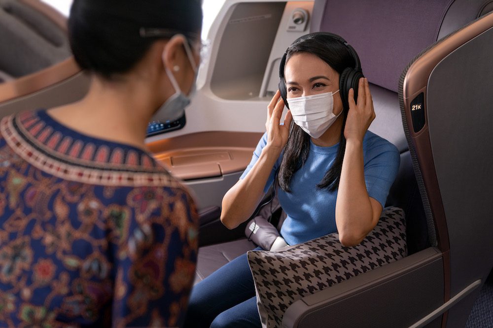 Singapore Airlines passenger wears a mask during Covid-era travel. Singapore Airlines