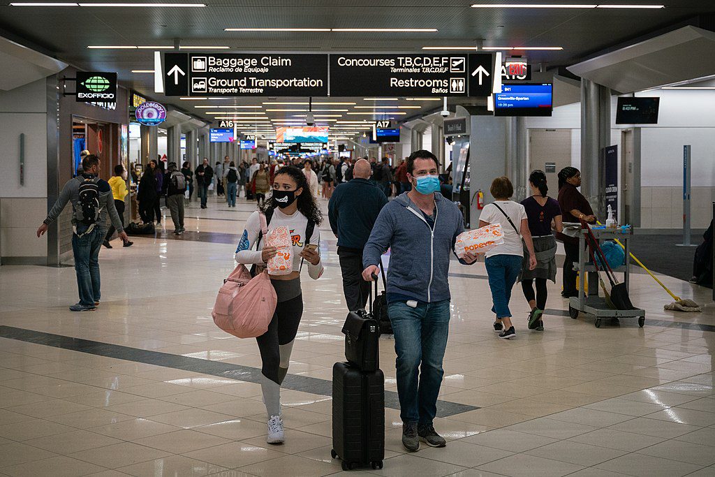 Masked travelers at Atlanta's international airport. The U.S. lifted it's travel ban on vaccinated travelers from nearly three dozen countries on November 8, 2021. 