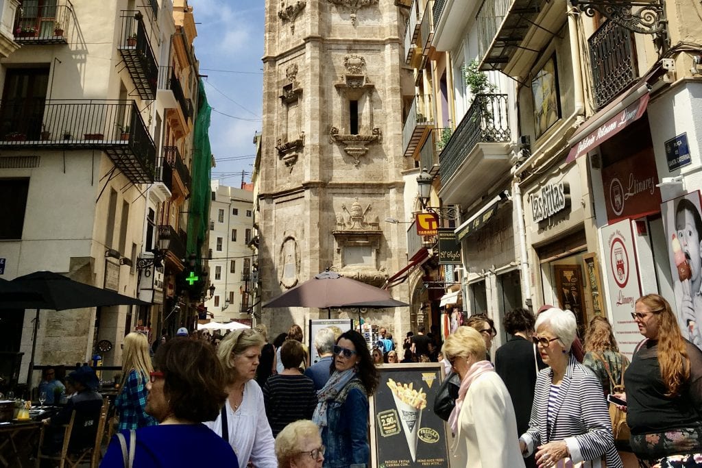 Pedestrians on a crowded street in Valencia, Spain. 
