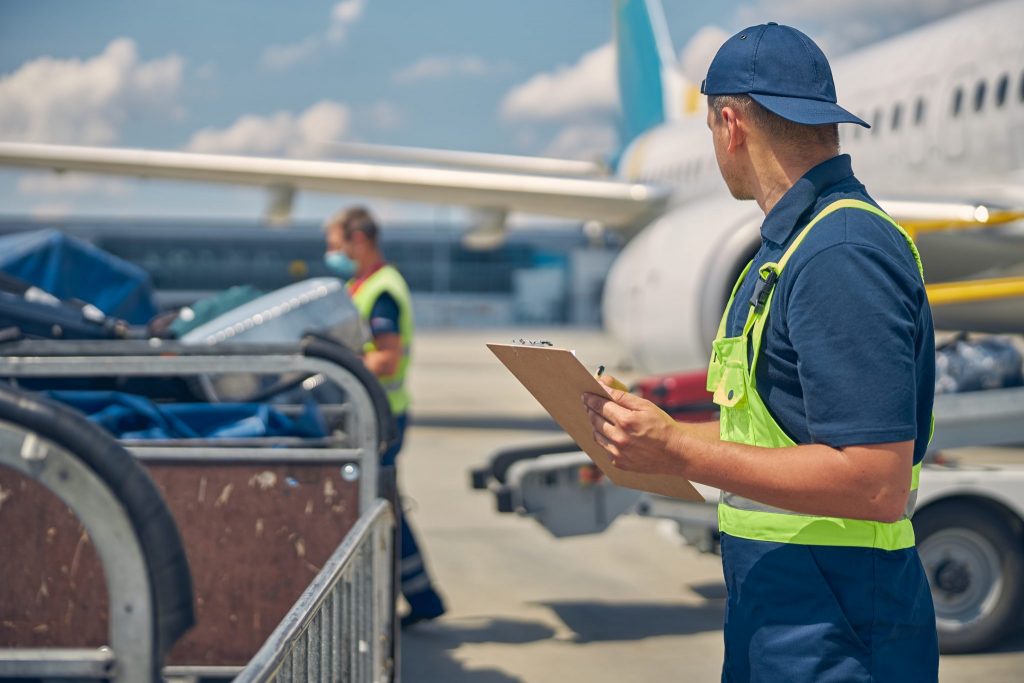 Man looking at a working baggage handler