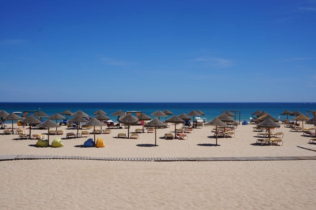 Beach umbrellas and the ocean in Lagos, Portugal. The United Kingdom removed the country from its coronavirus safe list today. 