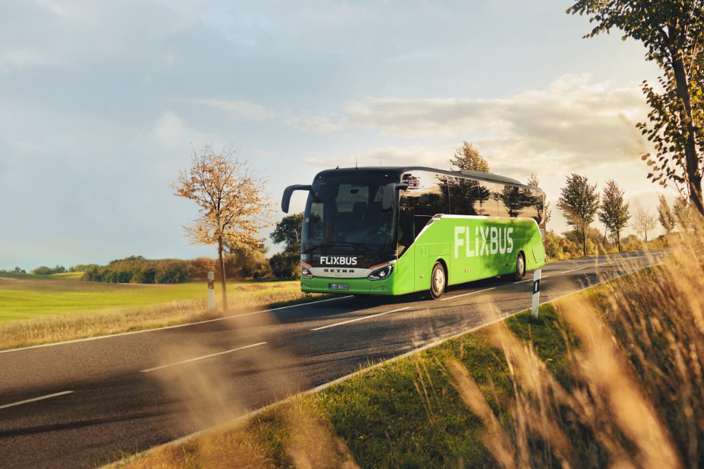 A FlixBus in a European landscape. The intercity bus brand belongs to FlixMobility, which has raised additional funding.