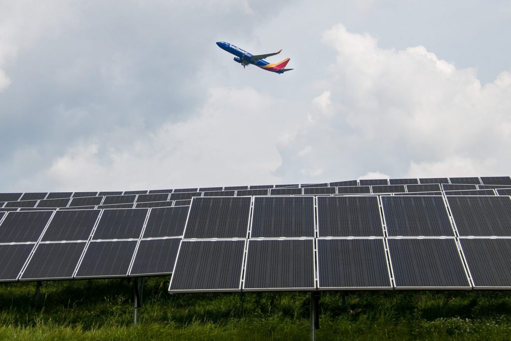 A plane flies over microgrids powering the entire campus at Pittsburgh International airport.