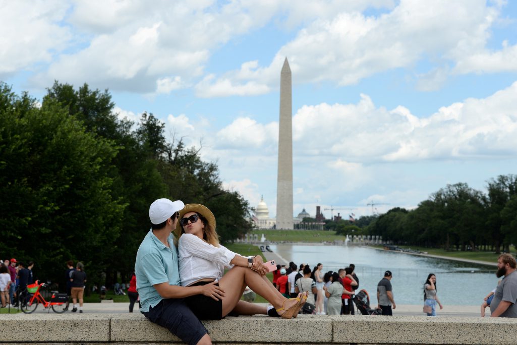 Daniel Flanagan and Zhadyra Darbayeva enjoy the weather at the Lincoln Memorial in Washington, U.S., July 3, 2021. 