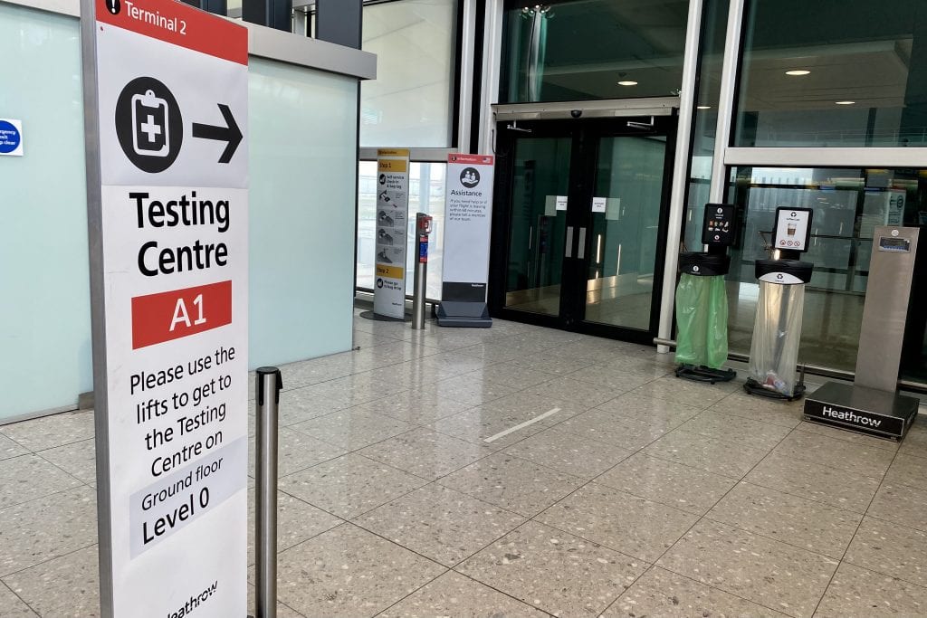 Sign for Covid testing center at departures level at Heathrow Airport's Terminal 2. 
