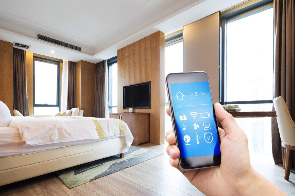 image of a smartphone being held up in a well-lit hotel room