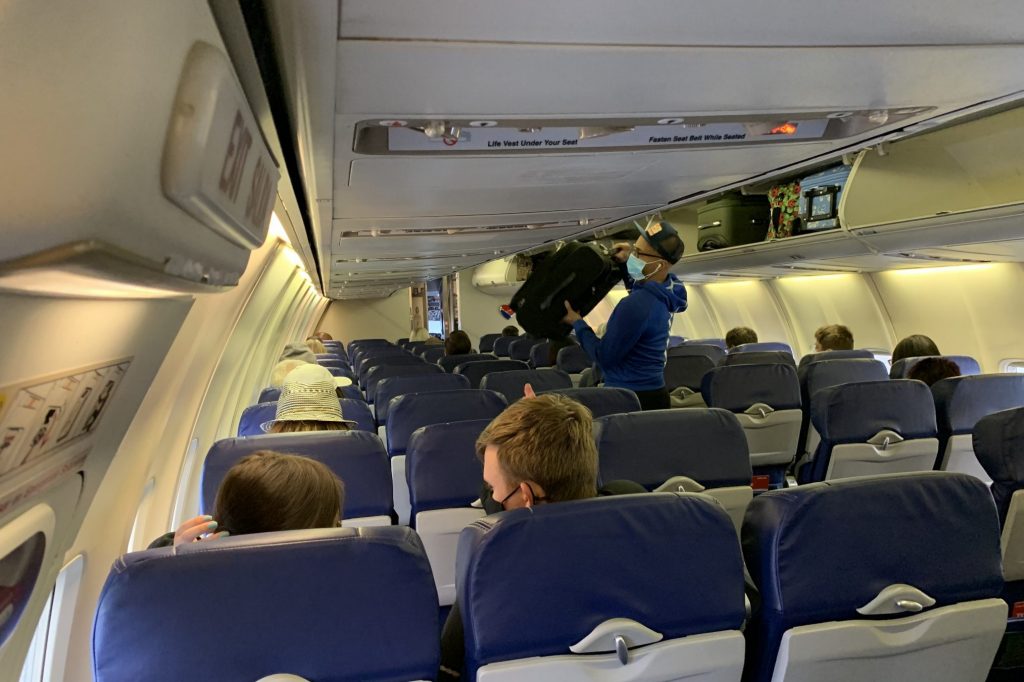 Airline passengers in this scaled down photo are complying with the mandatory mask mandate in airplanes extended through January, 2022.  