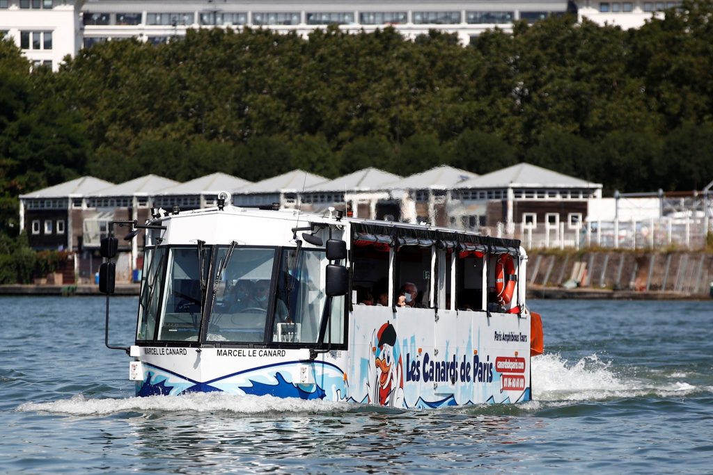 An amphibious bus named Marcel le Canard (Marcel The Duck) sails down the Seine river during a tour around Paris, August 25, 2021.
