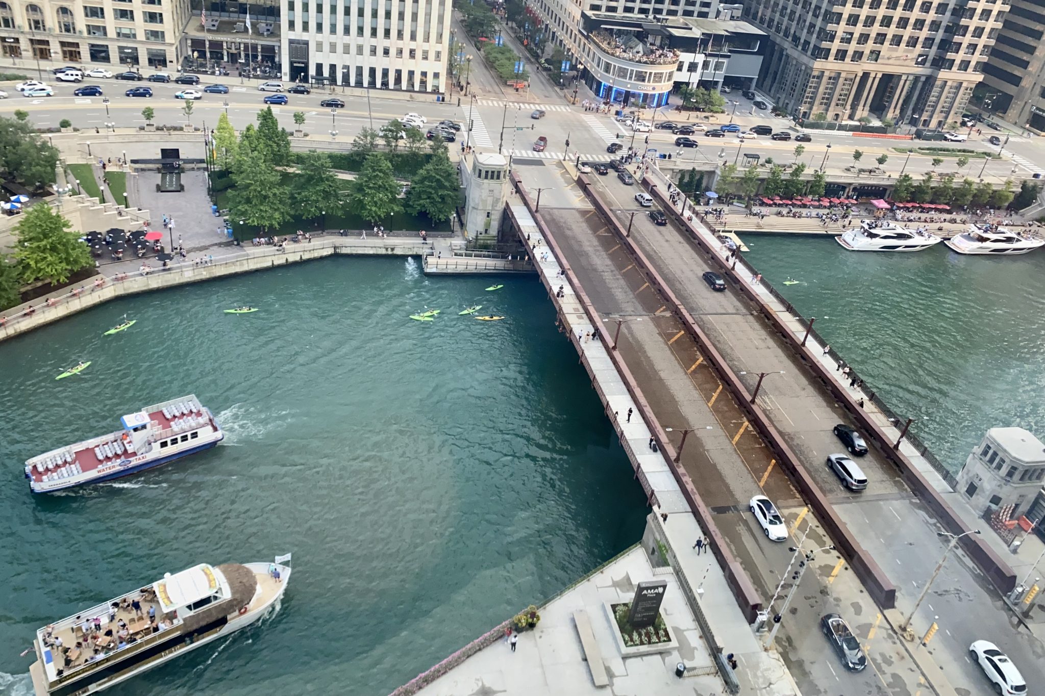 Tourist cruise boats and kayakers on the Chicago River. U.S. travel booking is on the upswing for spring and summer 2022. 