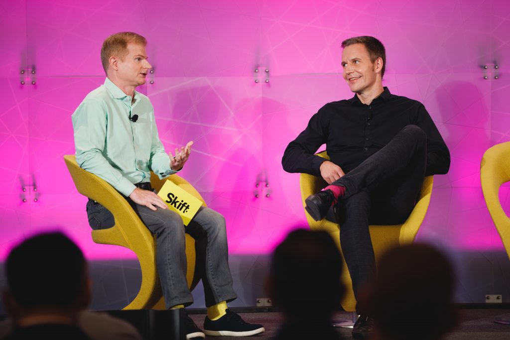 Trivago CEO Axel Hefer (R) speaking with Skift Travel Tech Editor Sean O'Neill at Skift Global Forum in New York City on September 21, 2021. Trivago thinks it could benefit if EU antitrust authorities crack down on Google in 2022.